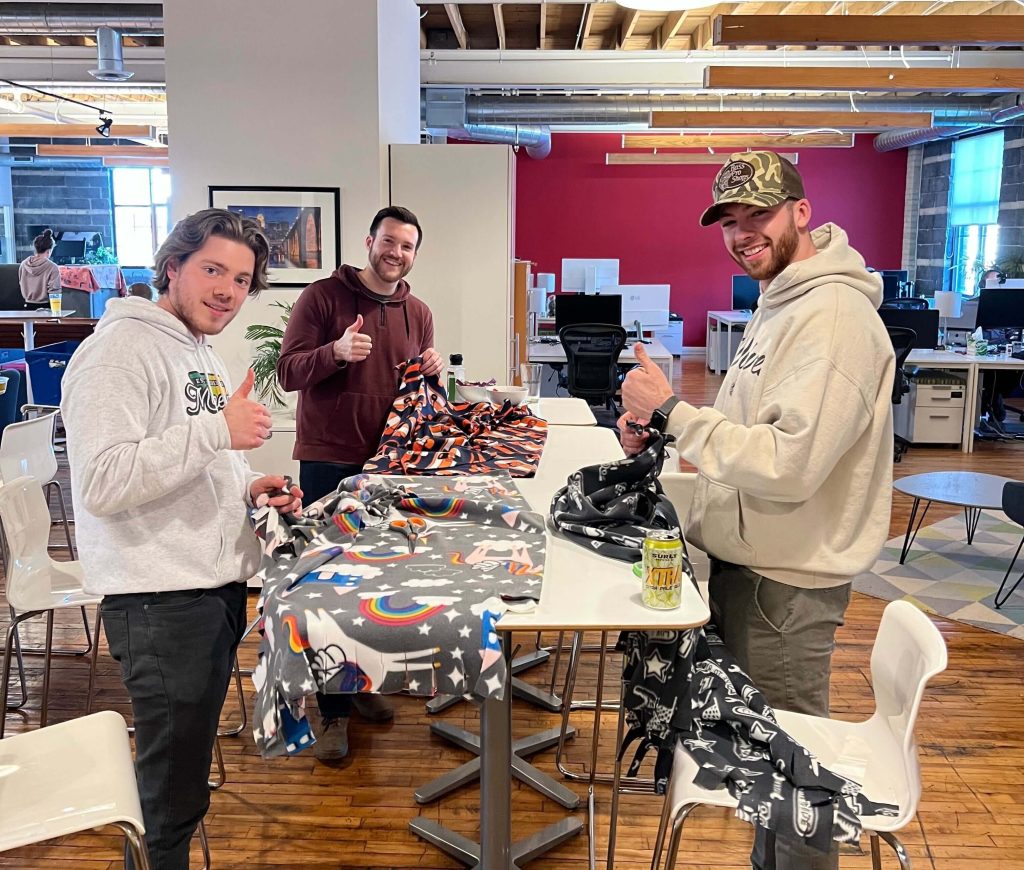 Augurian team members making blankets