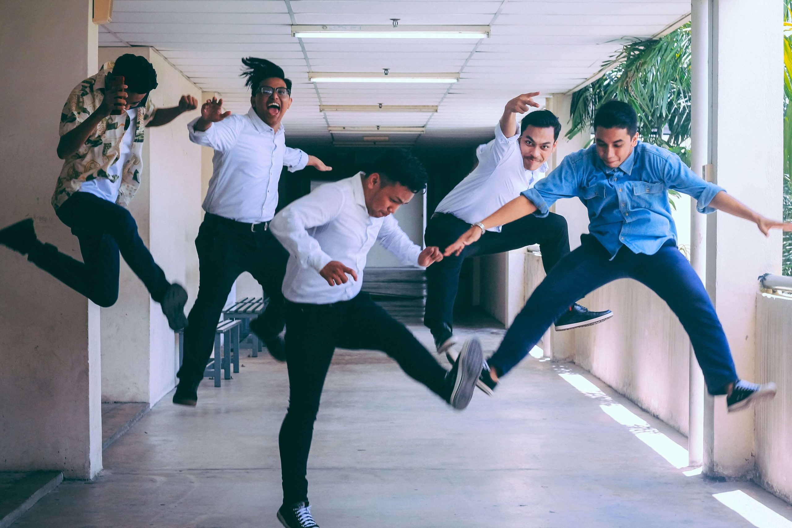 five employees jumping in the air