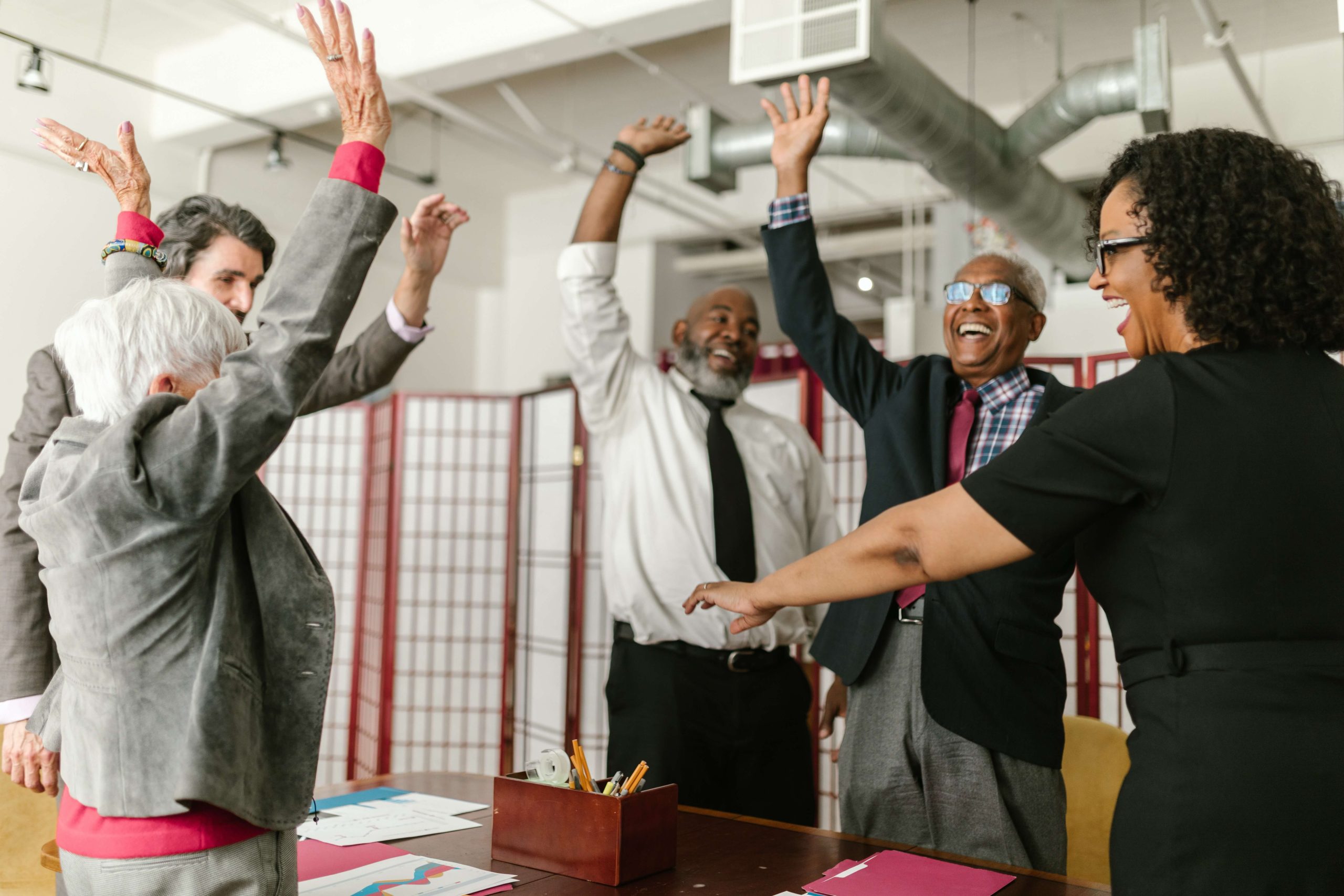 many team members with their hands in the air in celebration