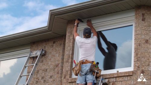 person fixing exterior home windows