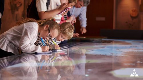 two children drawing at a science museum