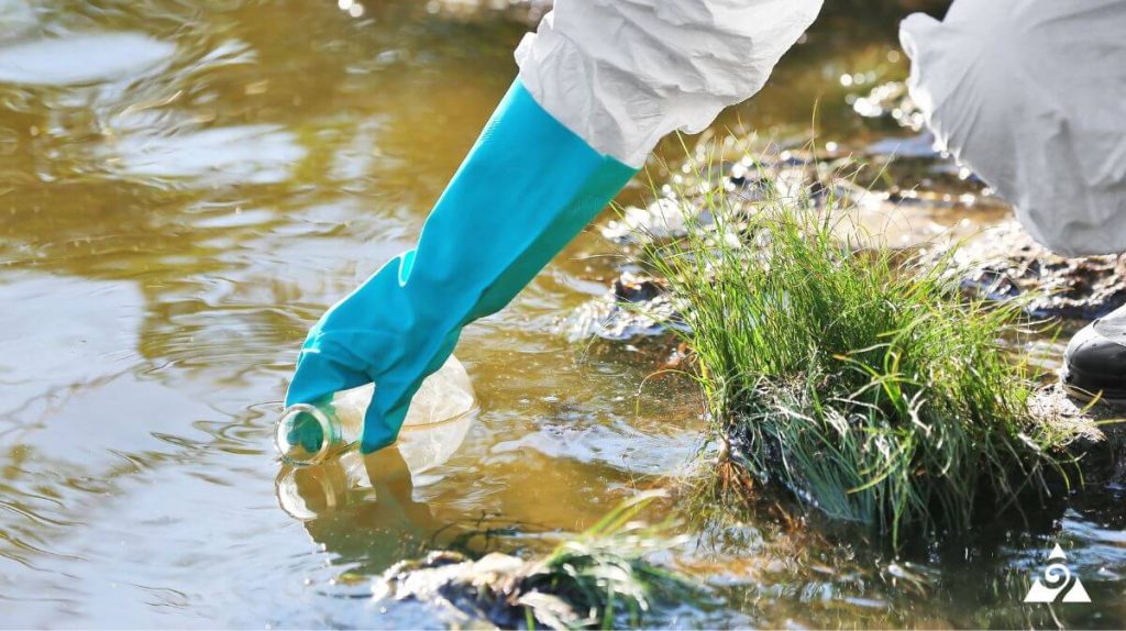 scientist collecting water from river