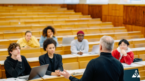students sitting in university listening to professor